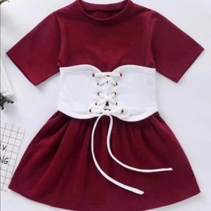 Burgundy toddler dress with white corset belt.
